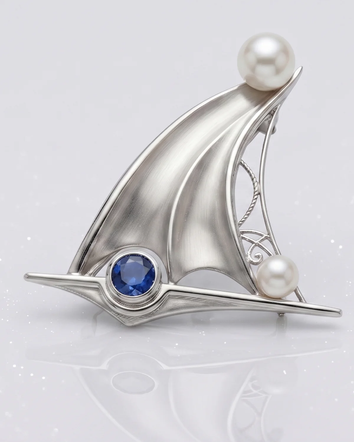 A memorial brooch — two natural pearls and a Ceylon sapphire on a sliding pin