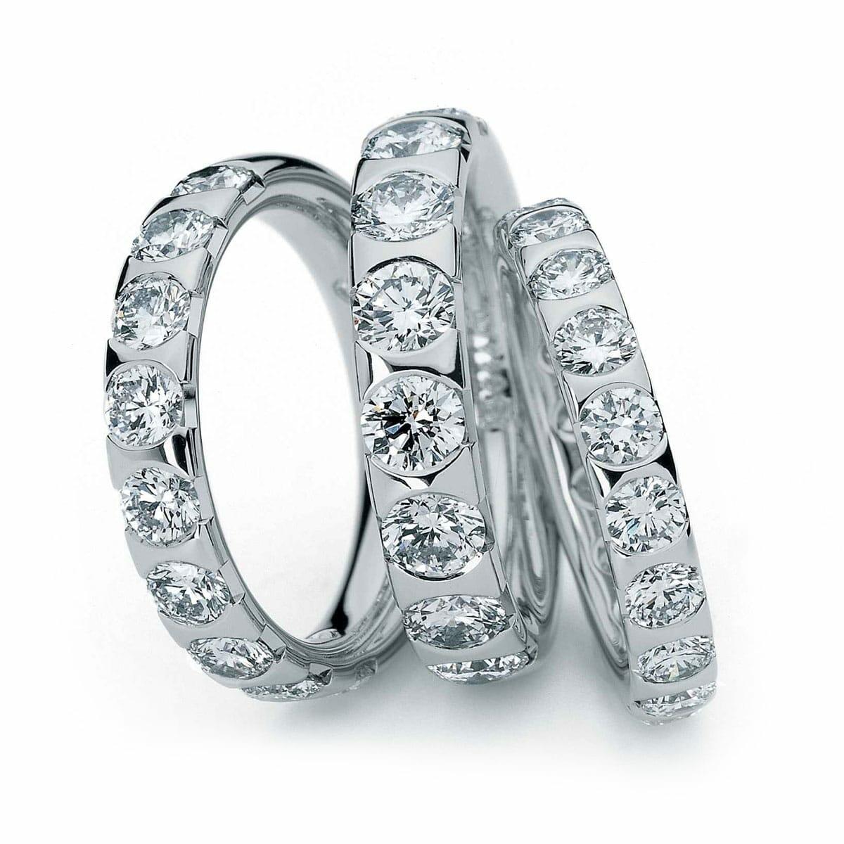 Thick White Gold Wedding Ring With Large White Diamonds Around Band
